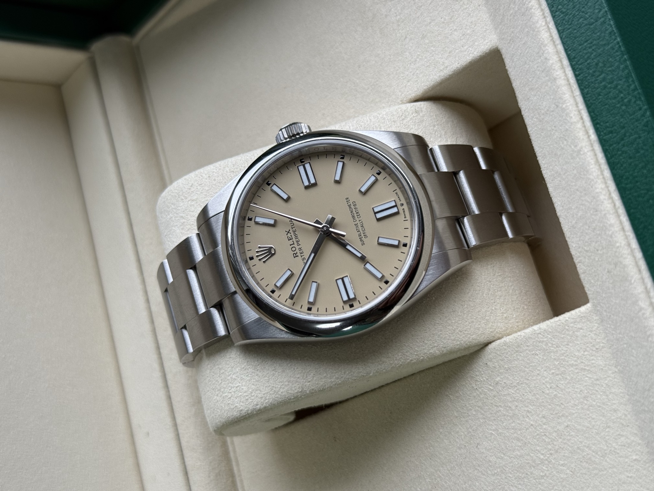 Rolex watch photographed on a dark leather surface